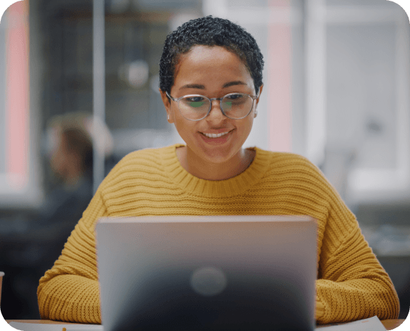 Woman at laptop, smiling